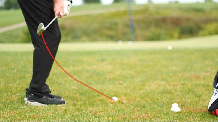 Dragging the club inside and around the body often causes golfers to hit behind or top chip shots